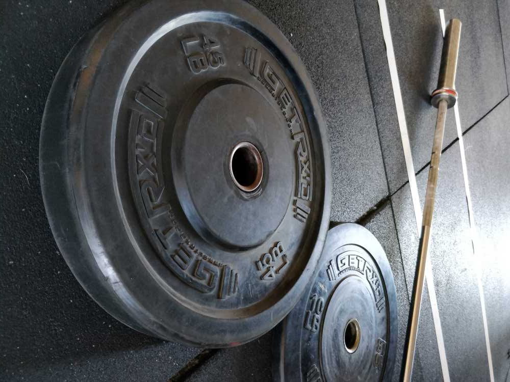 Workout equipment that is showing barbell and weights