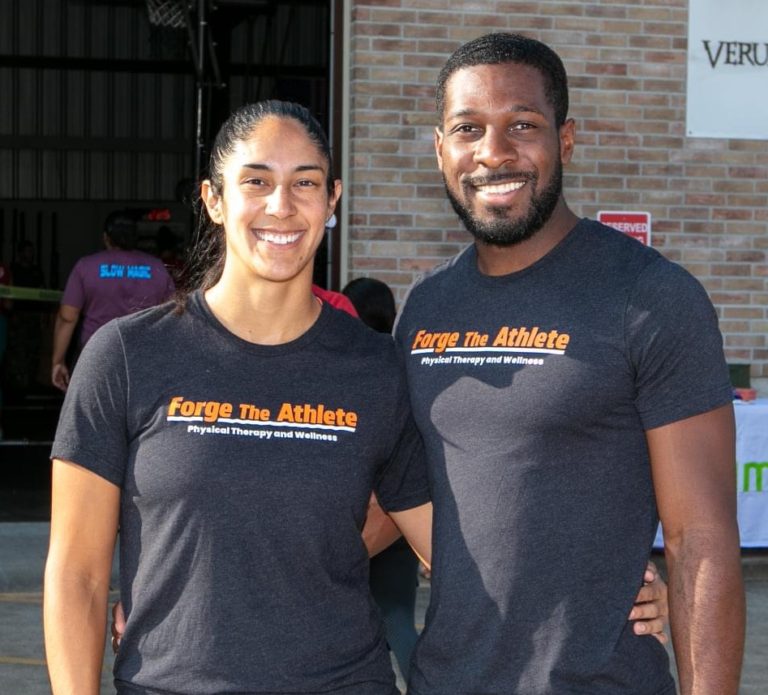 Physical therapy owners smiling at camera